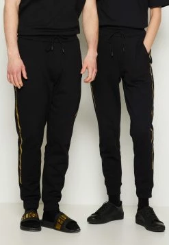 Meilleure vente 🌟 HUGO DOAK METALLIC UNISEX - Pantalon De Survêtement - Black/gold 😍