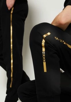 Meilleure vente 🌟 HUGO DOAK METALLIC UNISEX - Pantalon De Survêtement - Black/gold 😍 -HUGO Sales a2b0b86b110d49e9858647e08812ee91